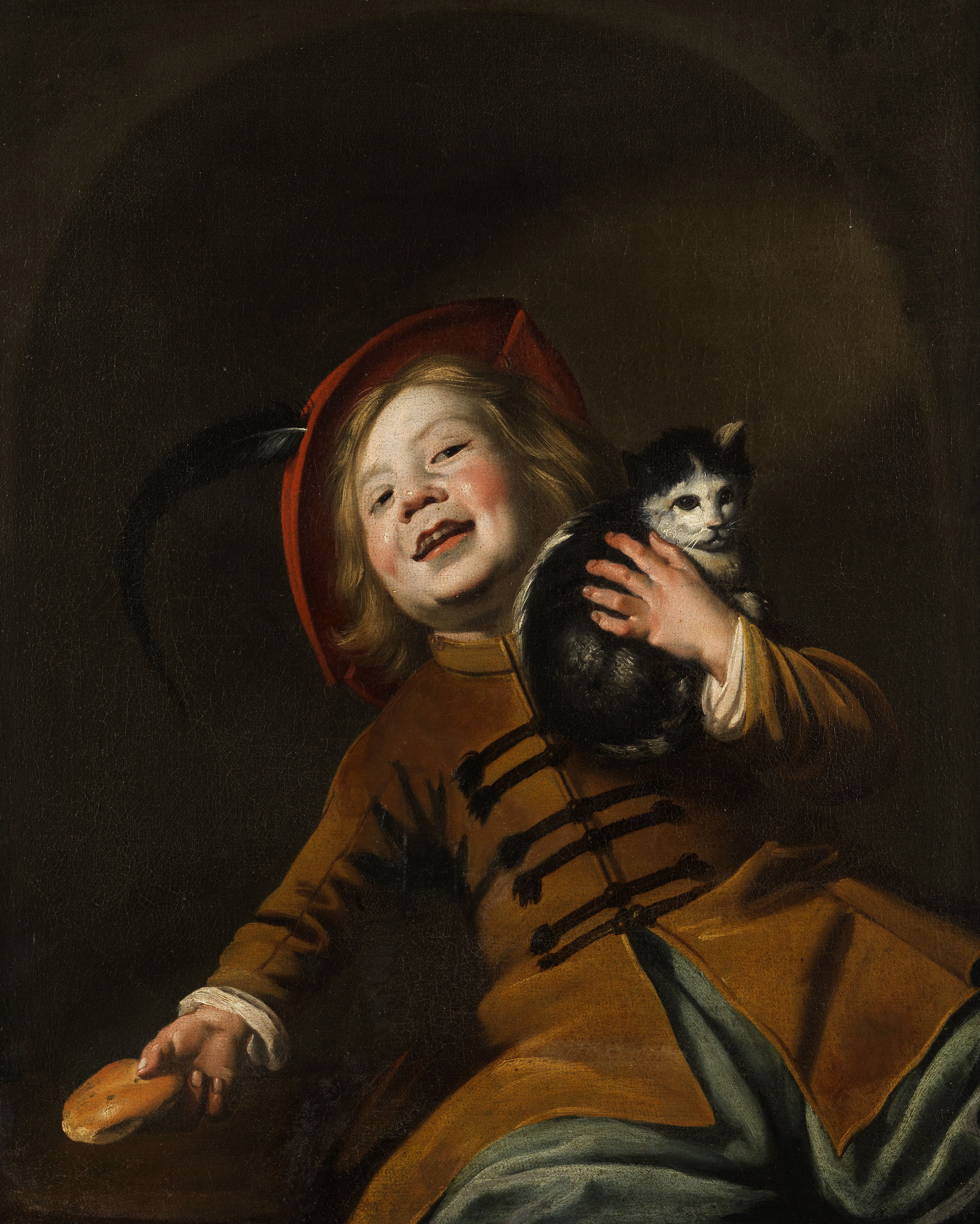 Boy with a cat, red hat and a piece of bread, zoomed in